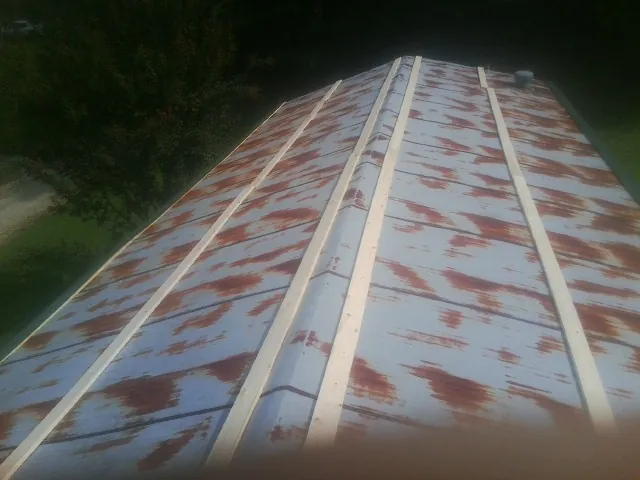 Rusted metal roof panels with new wood purlins before replacement — Storm Damage Roof Repair in Amarillo by Roofing Brothers