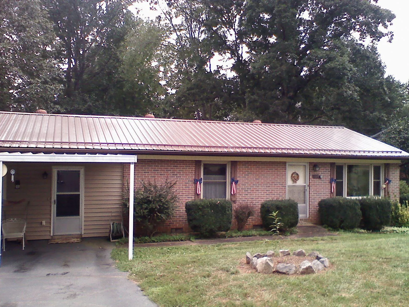 Bronze metal roof and carport on a brick ranch home — Roof Repair work by our crew in Amarillo